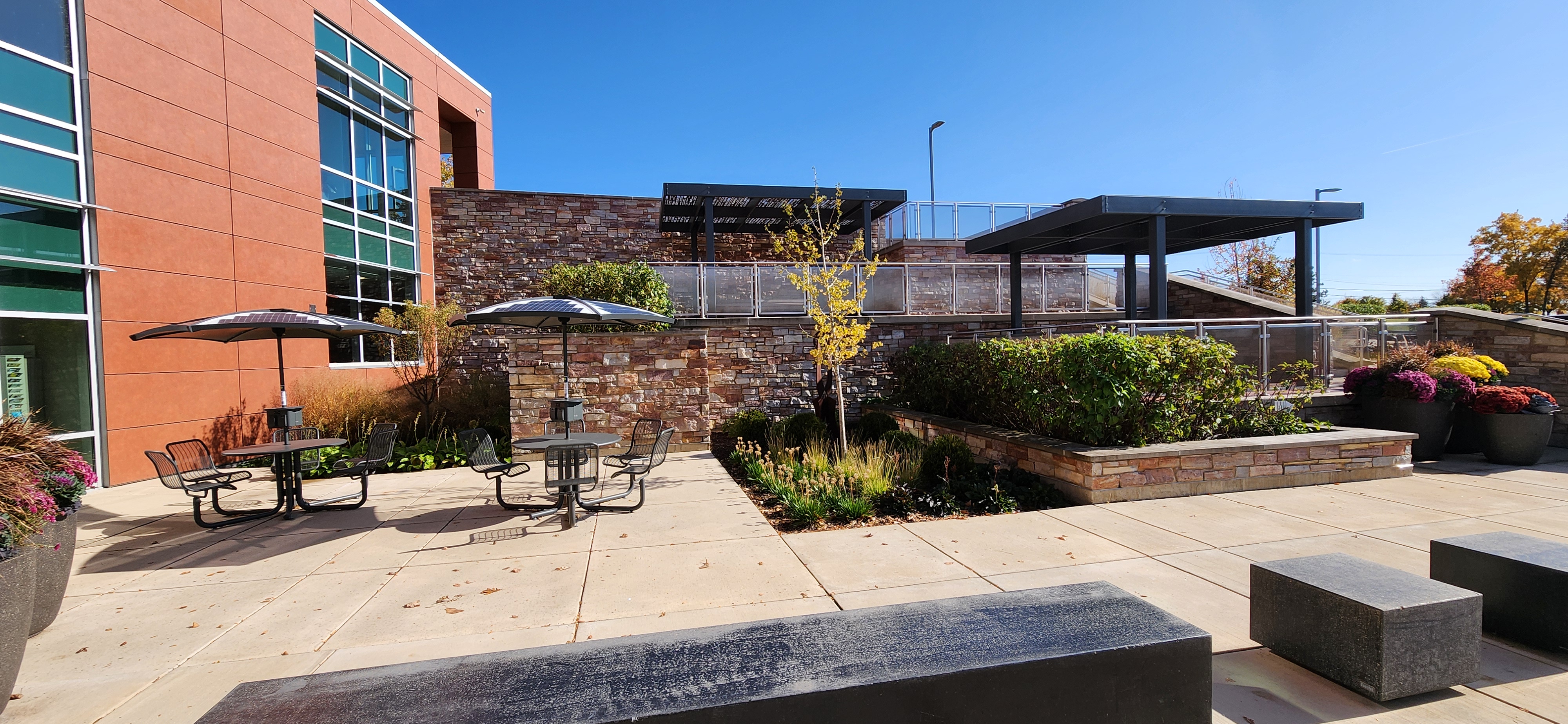 Full-view of the Library Garden which offers multiple seating options, shade and picturesque landscaping.