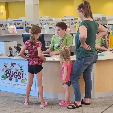 Jared Hedges, Youth Services Program Librarian, registers library patrons for the library’s 2024 summer reading program. 